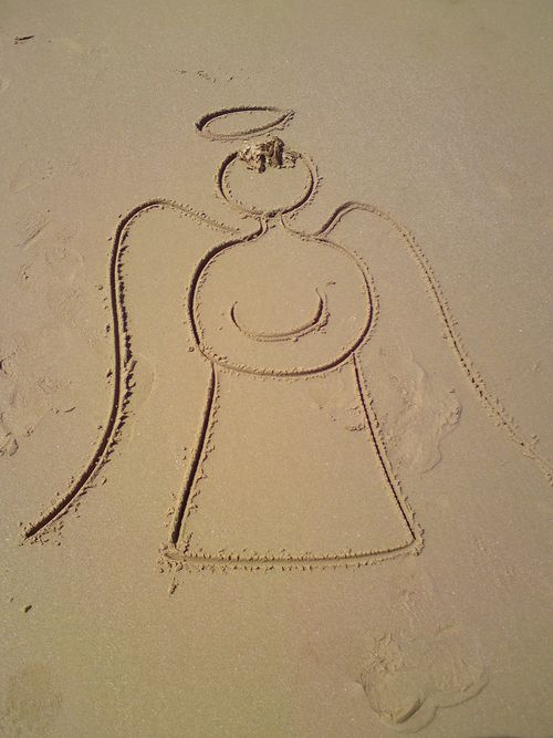 Angel drawn in the sand - sand writing