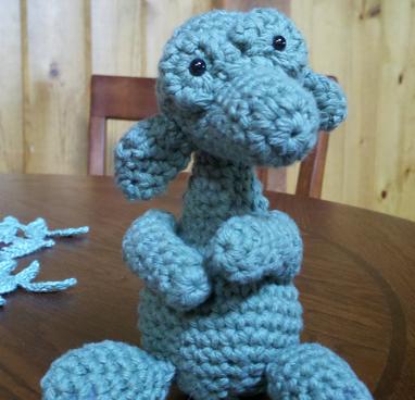 Blue crochet dinosaur toy