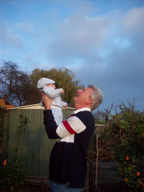 Grandad holding baby Grandson up to the sky